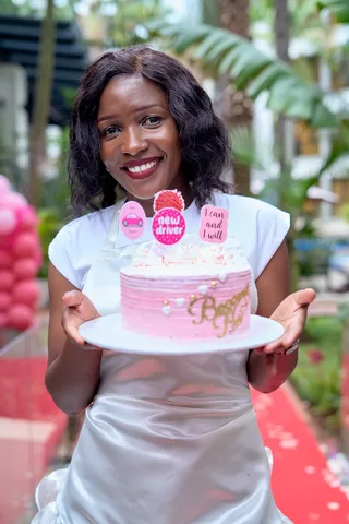 A guest celebrating her finished cake outdoors